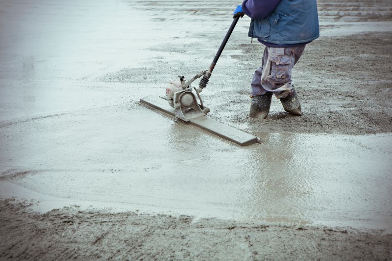 worker smoothing concrete surface