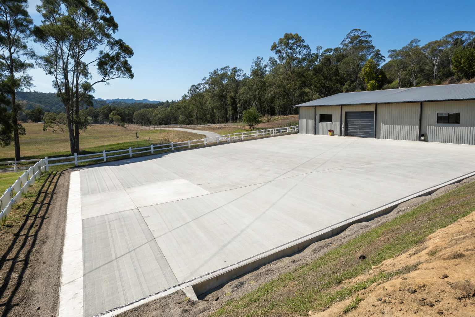 Professional concrete horse arena with smooth, level footing base