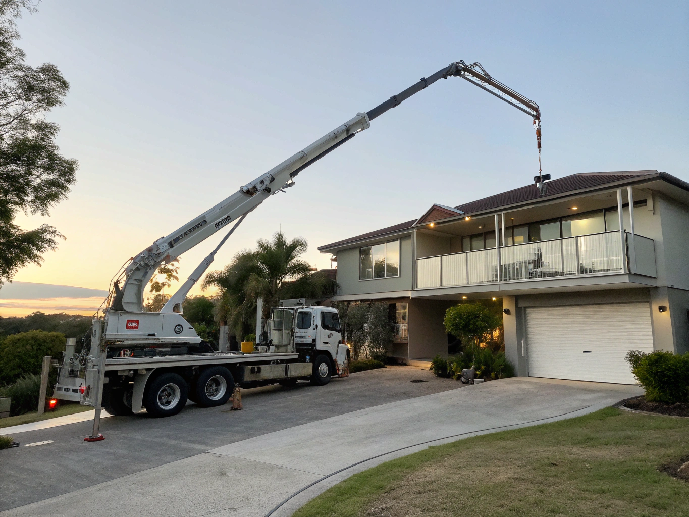 Concrete boom pump truck positioned on a residential Ipswich property