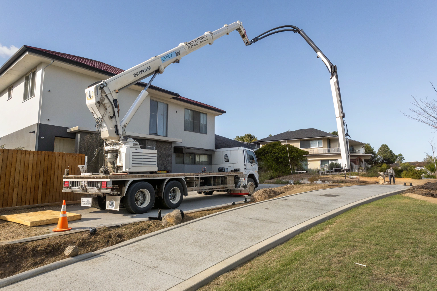 Concrete boom pump truck professionally positioned for an elevated pour