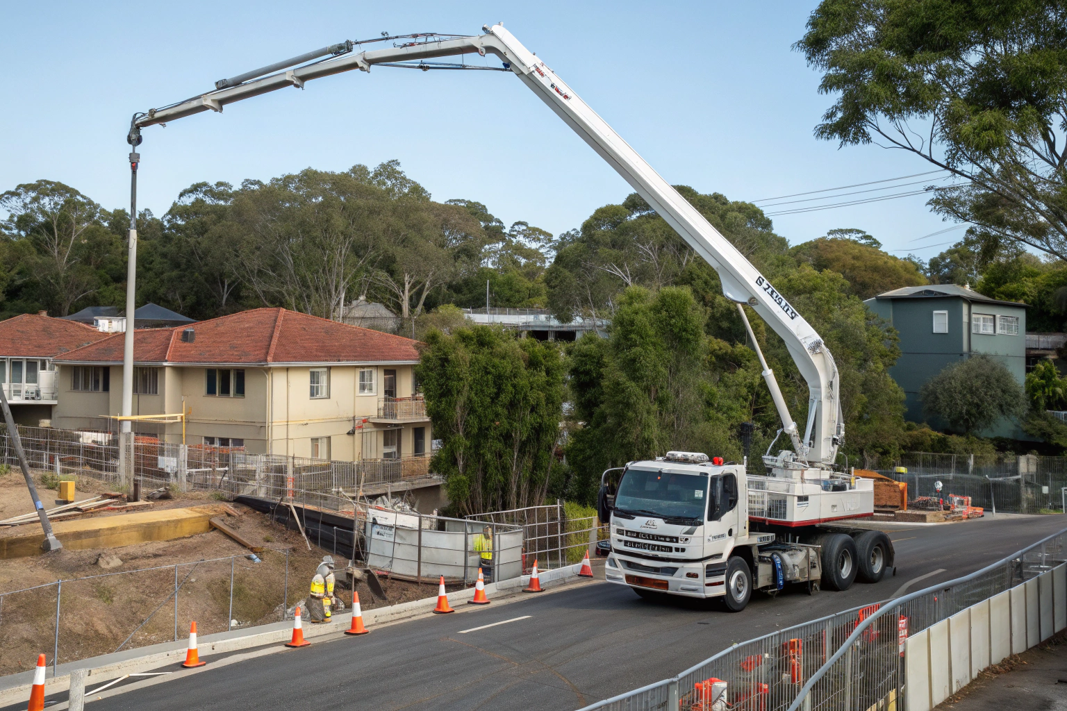 Concrete boom pump truck with articulated arm positioned for a pour