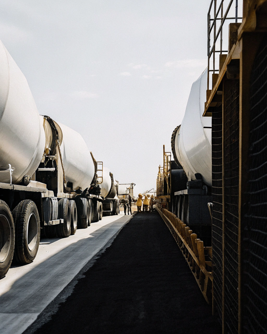 Coordinated multi-truck dispatch for continuous concrete pours on an Ipswich construction site