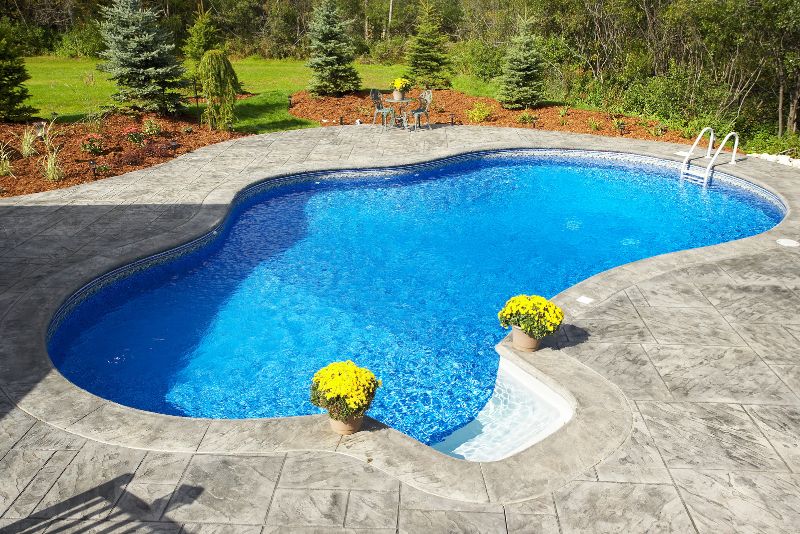 Stamped concrete pool surround with garden landscaping
